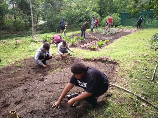 Muks doing community service in the school garden